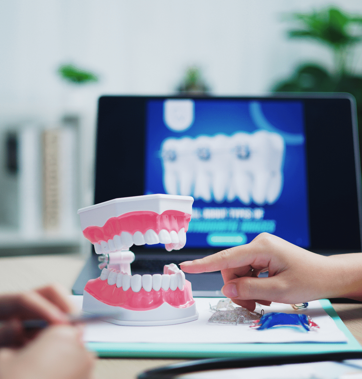 Dentist pointing at dental model of teeth